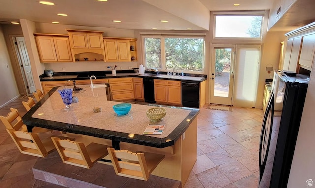 1657 N Kayenta Dr, Ivins, UT 84738 - kitchen with light brown cabinetry, black appliances, a breakfast bar, a sink, and recessed lighting