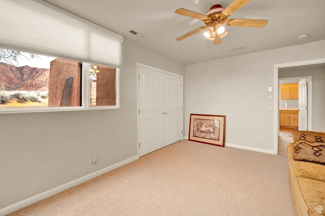 1657 N Kayenta Dr, Ivins, UT 84738 - unfurnished bedroom with light carpet, baseboards, a closet, and ceiling fan