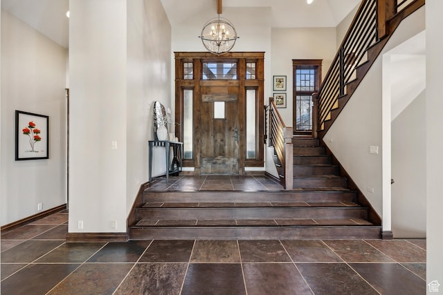 9255 Par Ct, Park City, UT 84098 - entrance foyer with stone tile flooring, a notable chandelier, stairs, and baseboards
