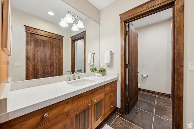 9255 Par Ct, Park City, UT 84098 - bathroom featuring vanity, a notable chandelier, toilet, and baseboards
