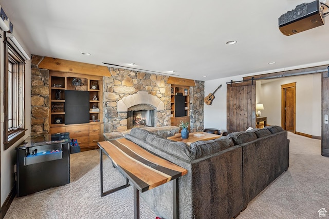 9255 Par Ct, Park City, UT 84098 - living area featuring recessed lighting, a barn door, carpet floors, a stone fireplace, and baseboards