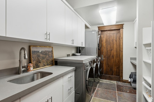 9255 Par Ct, Park City, UT 84098 - laundry area featuring a sink, cabinet space, stone finish floor, and washer and clothes dryer
