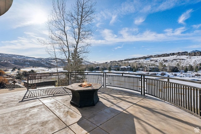 9255 Par Ct, Park City, UT 84098 - snow covered patio featuring a fire pit and a mountain view