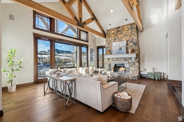 9255 Par Ct, Park City, UT 84098 - living area with baseboards, beam ceiling, a stone fireplace, hardwood / wood-style flooring, and high vaulted ceiling