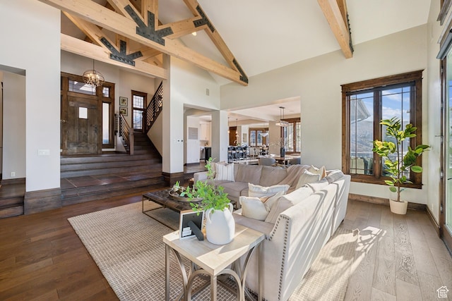 9255 Par Ct, Park City, UT 84098 - living area with beam ceiling, a notable chandelier, high vaulted ceiling, wood-type flooring, and stairs