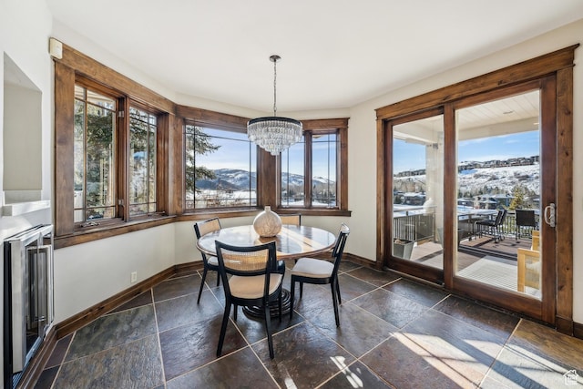 9255 Par Ct, Park City, UT 84098 - dining area with stone tile flooring, a chandelier, a mountain view, and baseboards