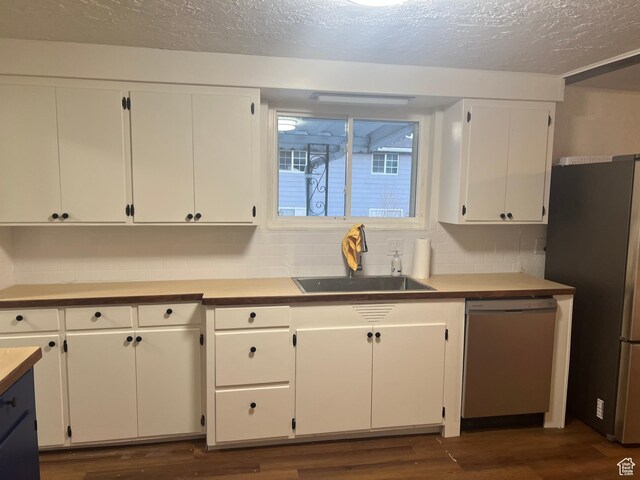 735 Castle Gate Rd, Helper, UT 84526 - kitchen featuring freestanding refrigerator, dark wood-style flooring, a sink, and dishwashing machine