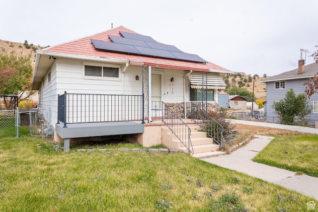 735 Castle Gate Rd, Helper, UT 84526 - view of front of house featuring a front yard, covered porch, fence, and solar panels