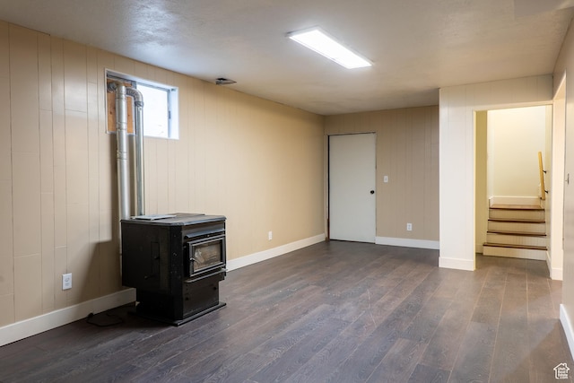 735 Castle Gate Rd, Helper, UT 84526 - below grade area featuring dark wood-style floors, stairs, a wood stove, and baseboards