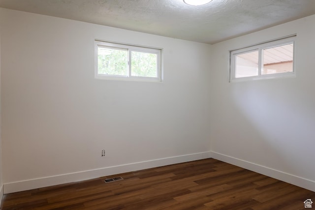 735 Castle Gate Rd, Helper, UT 84526 - spare room featuring dark wood-type flooring, visible vents, a textured ceiling, and baseboards