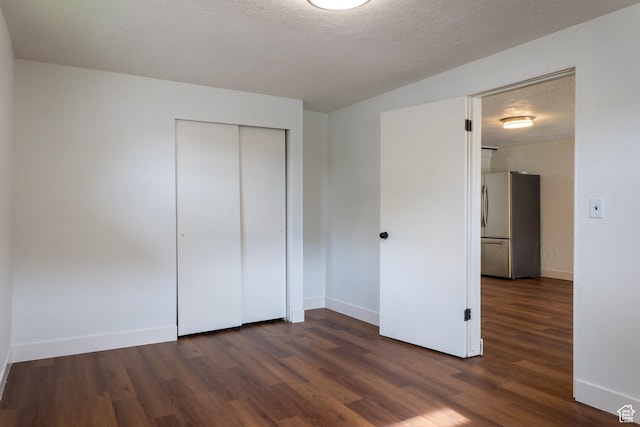 735 Castle Gate Rd, Helper, UT 84526 - unfurnished bedroom featuring a textured ceiling, wood finished floors, baseboards, a closet, and freestanding refrigerator