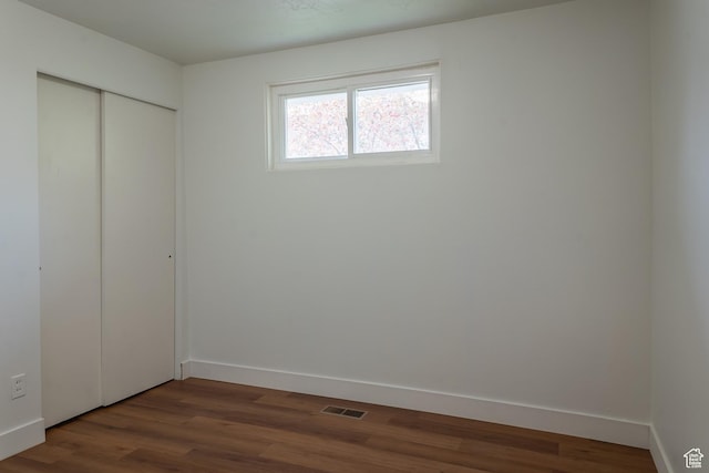 735 Castle Gate Rd, Helper, UT 84526 - unfurnished bedroom with a closet, visible vents, baseboards, and wood finished floors