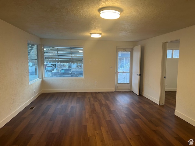 735 Castle Gate Rd, Helper, UT 84526 - empty room featuring a textured ceiling, a textured wall, dark wood-type flooring, and baseboards
