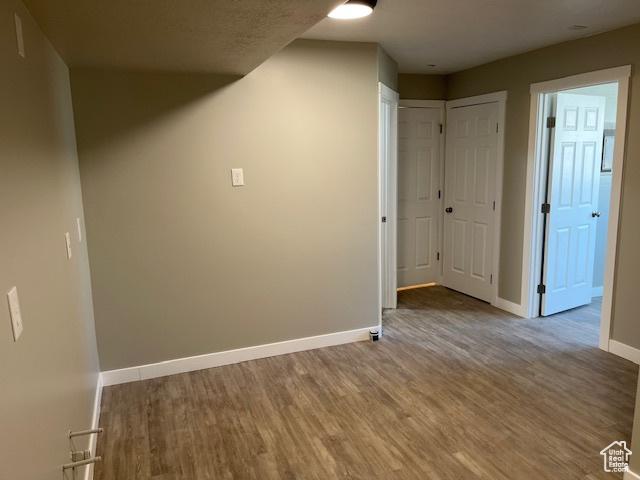 interior space featuring baseboards and wood finished floors