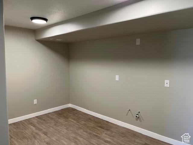 finished below grade area with dark wood finished floors and baseboards