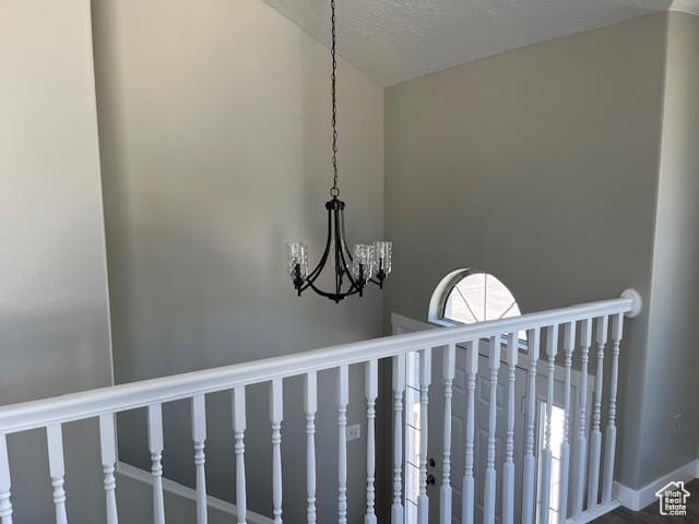 interior details featuring a chandelier and a textured ceiling