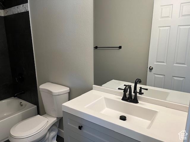 full bathroom with  shower combination, vanity, and toilet
