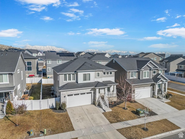 134 N Eden Brook Way, Saratoga Springs, UT 84045 - view of front of home featuring a garage, driveway, fence, and a residential view