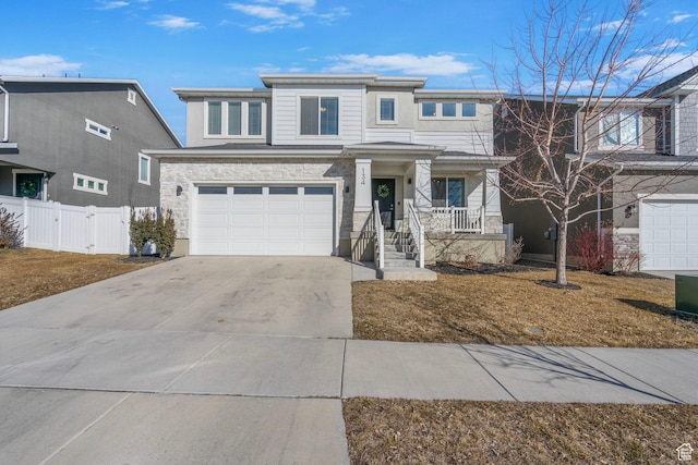 view of front of home with a gate, fence, a garage, stone siding, and driveway