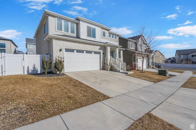 134 N Eden Brook Way, Saratoga Springs, UT 84045 - traditional home with driveway, stone siding, a residential view, an attached garage, and a gate