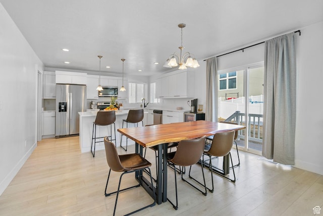 134 N Eden Brook Way, Saratoga Springs, UT 84045 - dining area with light wood-style floors, recessed lighting, baseboards, and an inviting chandelier