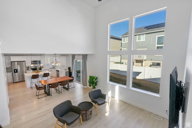 134 N Eden Brook Way, Saratoga Springs, UT 84045 - interior space with a towering ceiling, light wood-style floors, baseboards, and visible vents