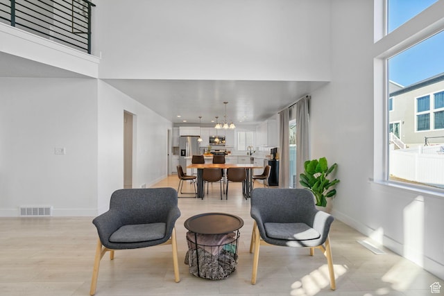 134 N Eden Brook Way, Saratoga Springs, UT 84045 - living area with a towering ceiling, an inviting chandelier, and baseboards