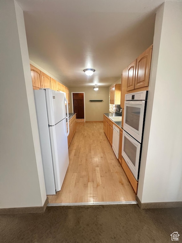 305 N 200 E, Elsinore, UT 84724 - kitchen with light carpet, white appliances, light brown cabinets, and baseboards