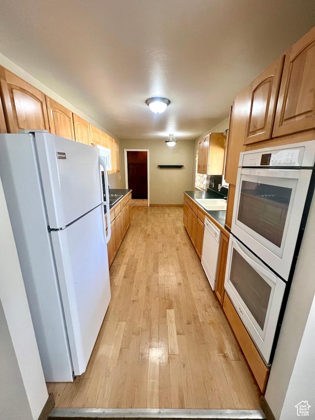 305 N 200 E, Elsinore, UT 84724 - kitchen featuring light wood-type flooring, white appliances, and a sink