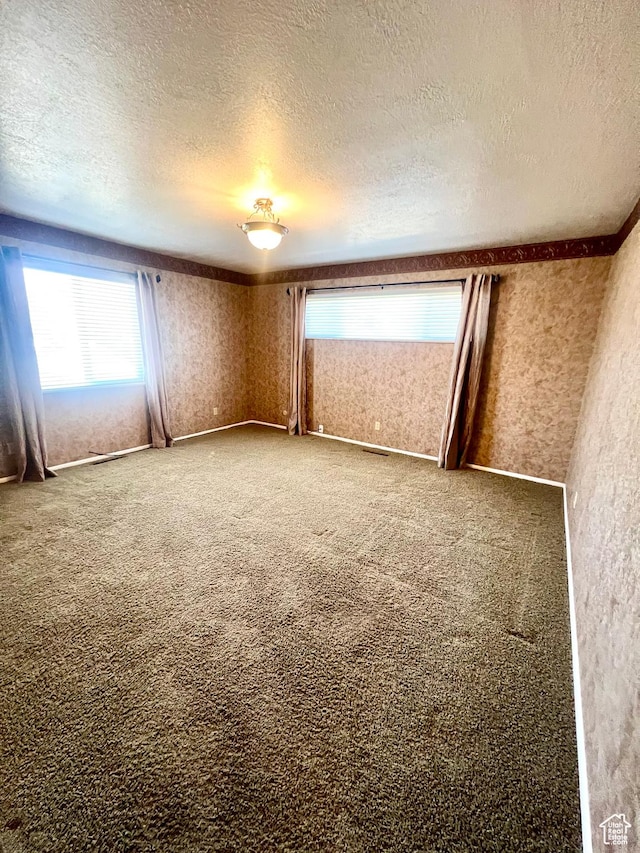 305 N 200 E, Elsinore, UT 84724 - carpeted spare room featuring a textured ceiling and wallpapered walls
