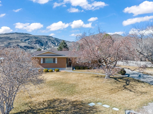 305 N 200 E, Elsinore, UT 84724 - view of front of house featuring brick siding, a mountain view, and a front lawn