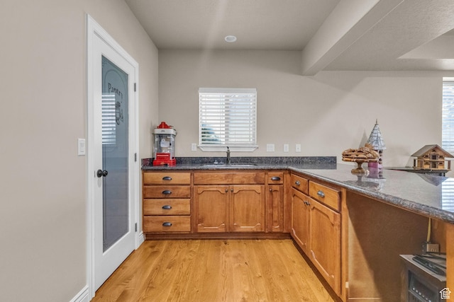 990 W Adams Cir, Bluffdale, UT 84065 - kitchen featuring light wood-style floors, a wealth of natural light, brown cabinets, and a sink