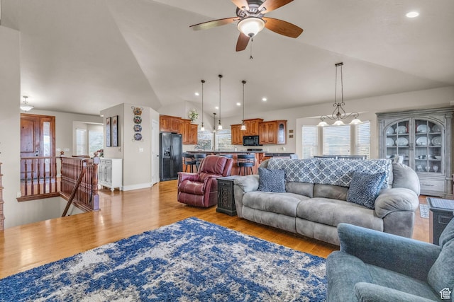 990 W Adams Cir, Bluffdale, UT 84065 - living area featuring recessed lighting, vaulted ceiling, light wood-style flooring, and ceiling fan with notable chandelier