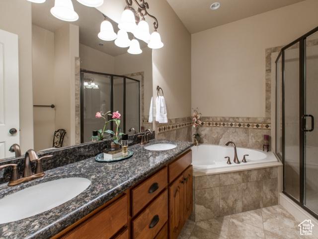 990 W Adams Cir, Bluffdale, UT 84065 - bathroom featuring a garden tub, a shower stall, and a sink