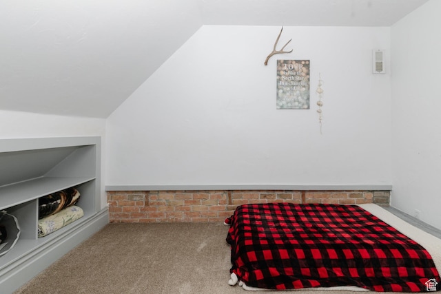 carpeted bedroom with lofted ceiling