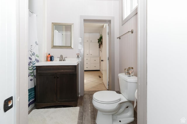 full bathroom with tile patterned floors, vanity, and toilet