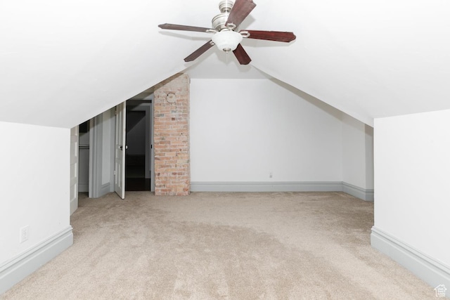 bonus room with carpet, lofted ceiling, baseboards, and ceiling fan