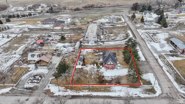 snowy aerial view with a residential view