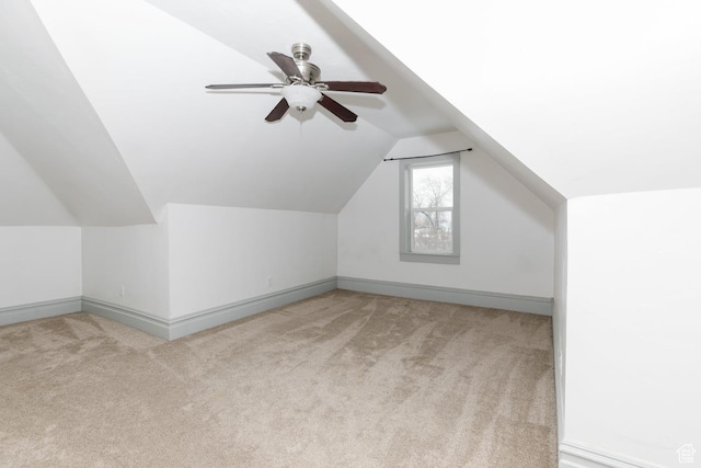 bonus room with light colored carpet, baseboards, and lofted ceiling