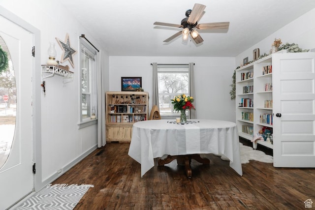 dining space featuring ceiling fan and dark wood-style flooring