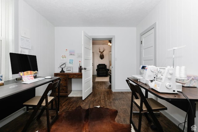 office featuring a textured ceiling, a ceiling fan, and dark wood-style flooring