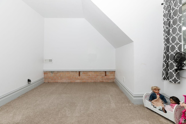 bonus room featuring lofted ceiling and carpet