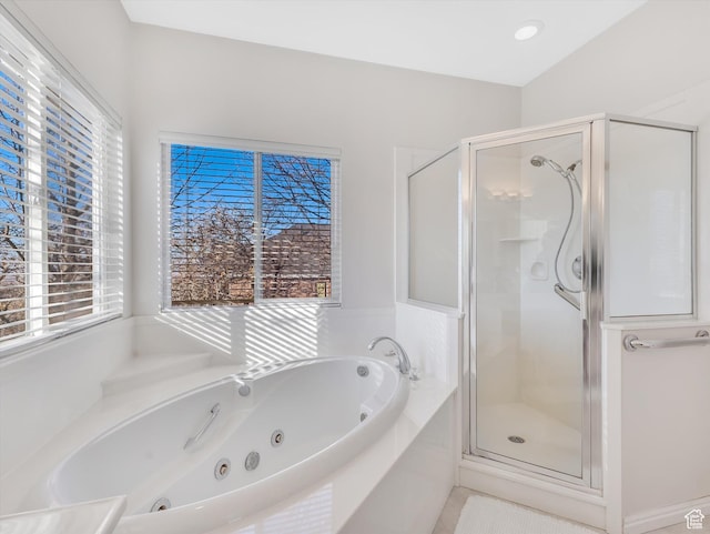 full bath with a stall shower and a tub with jets
