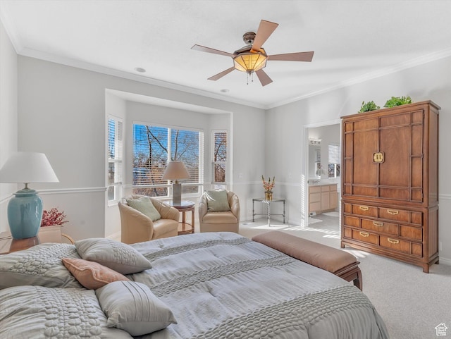 bedroom with baseboards, a ceiling fan, light colored carpet, ensuite bathroom, and crown molding