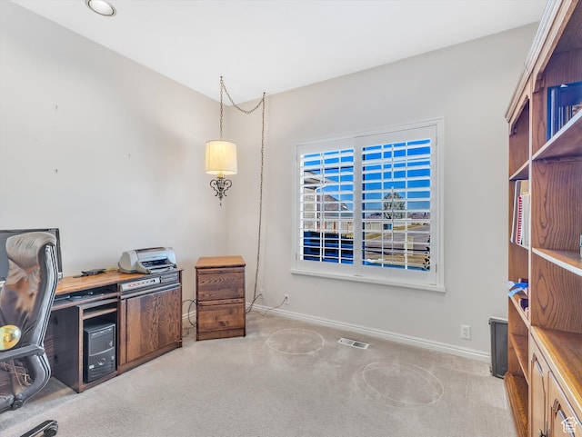 carpeted office space with visible vents and baseboards