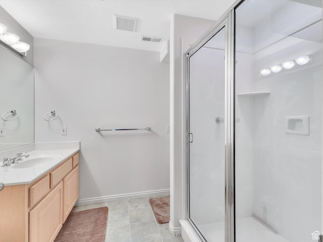 full bath featuring vanity, a shower stall, and visible vents
