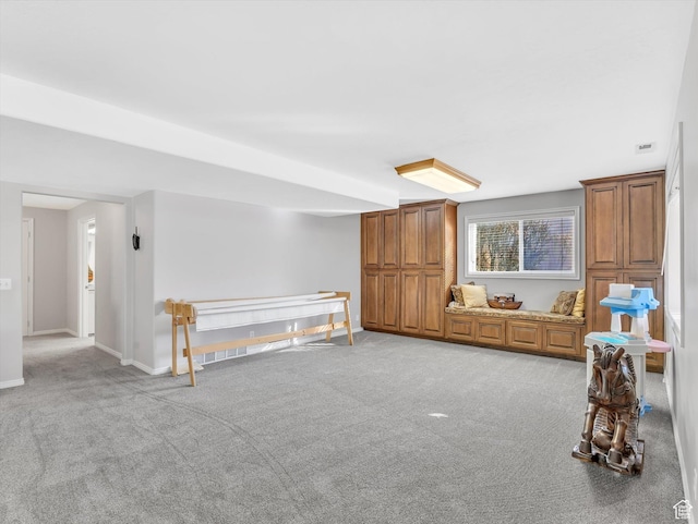 interior space featuring light carpet and baseboards
