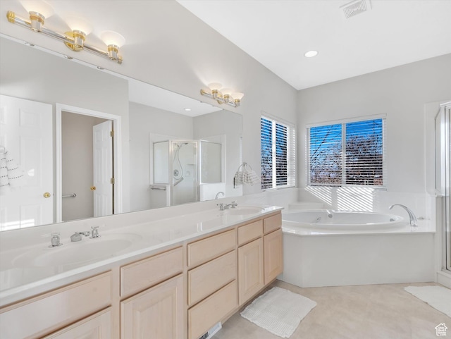 full bath featuring a garden tub, a sink, visible vents, a shower stall, and double vanity