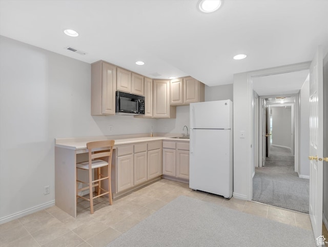 kitchen with recessed lighting, visible vents, freestanding refrigerator, a sink, and black microwave