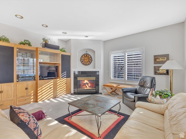 carpeted living room featuring recessed lighting and a tiled fireplace